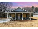 Lovely home with a quaint porch and a neatly manicured front yard at 411 S Spargo St, Dallas, NC 28034