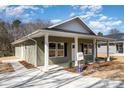 Inviting exterior showcasing a well-maintained home with a concrete walkway and covered porch at 411 S Spargo St, Dallas, NC 28034