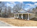 Well-kept home featuring a classic design, landscaped yard and a welcoming covered porch at 411 S Spargo St, Dallas, NC 28034
