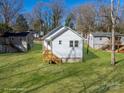 Well-maintained backyard showcasing a newly renovated home with a charming, covered back porch at 427 Queens Ct, Gastonia, NC 28052