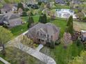 Aerial view of a well-maintained property with pond access and lush landscaping at 5005 Autumn Blossom Ln, Waxhaw, NC 28173