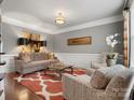 Elegant living room with crown molding, wainscoting, designer rug, and sophisticated decor at 5005 Autumn Blossom Ln, Waxhaw, NC 28173
