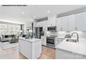 This new kitchen displays stainless appliances, white cabinets, quartz countertops, and an island at 6010 Fonsac Ln # 2006C, Charlotte, NC 28217