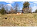 View of the home featuring a two-car garage and the surrounding wooded area at 605 18Th Nw St, Hickory, NC 28601
