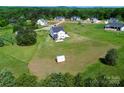 Expansive lot with well-maintained lawn featuring home, shed, and lush green trees in a desirable neighborhood at 623 Plowshare Way, Clover, SC 29710