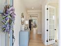 Inviting entryway featuring hardwood floors, stylish console table, and elegant decor at 623 Plowshare Way, Clover, SC 29710