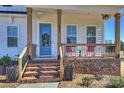 Charming front porch with brick stairs, rocking chairs, and craftsman-style detailing at 623 Plowshare Way, Clover, SC 29710