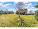 Spacious backyard with lush green lawn and mature trees at 8137 Caliterra Dr, Charlotte, NC 28227