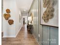 Bright hallway featuring wood-look floors and paneled wall accents leading to the home's living areas at 960 Exeter Dr, Sherrills Ford, NC 28673