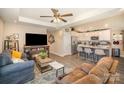 Inviting living room features a ceiling fan, a fireplace, comfortable seating, and access to the kitchen area at 1016 E 10Th St, Kannapolis, NC 28083