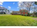 Classic brick home with a spacious front lawn and green shutters, offering a traditional and inviting curb appeal at 1301 Old Farm Rd, Charlotte, NC 28226