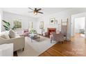Bright living room with hardwood floors, fireplace, neutral furniture, and abundant natural light at 1416 Woodland Dr, Charlotte, NC 28205