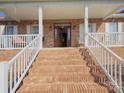 Inviting front entrance featuring brick steps, white railings, and a beautiful wooden front door with glass detailing at 144 Grandview Dr, Statesville, NC 28677