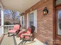 Cozy front porch with rocking chairs and a side table, perfect for relaxing and enjoying the outdoors at 144 Grandview Dr, Statesville, NC 28677