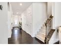 Elegant foyer with dark hardwood floors, staircase, and decorative accents at 14815 Superior St, Charlotte, NC 28273