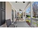 Relaxing front porch with comfortable chairs and ceiling fan at 16504 Knox Run Rd, Huntersville, NC 28078
