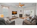 Cozy living room with a fireplace, comfortable seating, and an open layout at 16504 Knox Run Rd, Huntersville, NC 28078