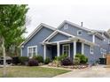 Stylish blue two-story home with white trim, a well-kept lawn, and an inviting entrance at 1703 Luther St, Charlotte, NC 28204