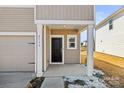 View of a covered front porch with white columns and a black front door at 2131 Belterra Dr, Charlotte, NC 28216