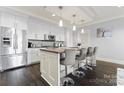 Modern kitchen featuring white cabinetry, stainless steel appliances, and large island at 222 S Caldwell St # 2008, Charlotte, NC 28202