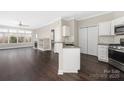 Inviting living space with a view into the kitchen, featuring hardwood floors and an open-concept design at 226 S Torrence St # 303, Charlotte, NC 28204