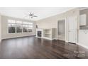 Bright living room featuring hardwood floors, large windows, and a cozy fireplace, perfect for relaxation at 226 S Torrence St # 303, Charlotte, NC 28204