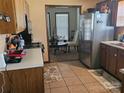Efficient kitchen layout with stainless steel appliances, neutral countertops, and tile flooring at 2630 Sloan Dr, Charlotte, NC 28208