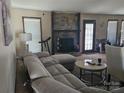 Comfortable living room featuring a stone fireplace, plush sofa, and natural light from the window at 2630 Sloan Dr, Charlotte, NC 28208