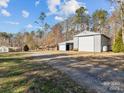 Spacious outbuilding features ample storage and workspace, perfect for hobbies or business ventures at 265 River Run Rd, Statesville, NC 28625