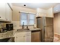 Bright kitchen with stainless steel appliances, granite countertops, and white cabinets at 2719 Selwyn Ave # 6, Charlotte, NC 28209