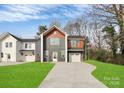 Contemporary two-story home with mixed siding, an attached garage, and a long driveway at 2751 Bradford St, Gastonia, NC 28052