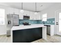Stylish kitchen featuring stainless steel appliances, a center island, and blue backsplash at 2765 Bradford St, Gastonia, NC 28054