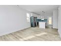 Bright, open-concept living space with hardwood floors and white walls at 2765 Bradford St, Gastonia, NC 28054
