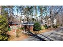 Residential street view of a charming brick home with mature trees creating a canopy at 2921 Fort St, Charlotte, NC 28205