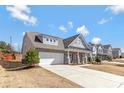 Beautiful home with a long driveway, two-car garage, and a covered front porch in a residential neighborhood at 2934 Hiddenbrook Way, Fort Mill, SC 29707