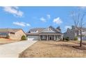 Inviting home with well-manicured lawn, covered porch, and a two-car garage on a sunny day at 2934 Hiddenbrook Way, Fort Mill, SC 29707