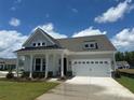 Inviting single-story home with a two-car garage, manicured lawn and covered front porch at 305 Basil Dr, Indian Trail, NC 28079