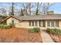 Inviting front view of a brick home with updated windows and manicured landscaping at 3200 Highview Rd, Charlotte, NC 28210
