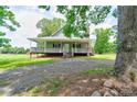Charming home featuring a covered porch, stone steps and a brick chimney at 3640 Oak Haven Ln, Shelby, NC 28150