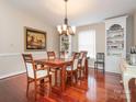 Dining room with hardwood floors, built-in shelving, chandelier, and space for large gatherings at 3711 Davis Dr, Charlotte, NC 28270