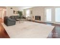 Bright living room featuring hardwood floors, a stone fireplace, and ample space for entertaining guests at 3711 Davis Dr, Charlotte, NC 28270