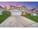 Charming two-story home with a well-maintained lawn, landscaping, and a spacious driveway at 433 Annaberg Ln, Monroe, NC 28110