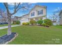 Landscaped front yard with a large tree and a well-maintained lawn at 433 Annaberg Ln, Monroe, NC 28110