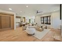 Open-concept space with light wood floors seamlessly connects the living and dining areas at 4808 Doris Ave, Charlotte, NC 28205