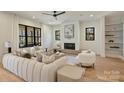 Cozy living room boasting a fireplace, neutral tones, and lots of natural light at 4808 Doris Ave, Charlotte, NC 28205