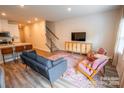 Open living room flows into the kitchen with sleek floors, staircase, and lots of natural light at 508 Tayberry Ln, Fort Mill, SC 29715