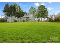 Expansive backyard featuring a well-maintained lawn, detached garage, and a charming gazebo at 56 Linneys Mountain Rd, Taylorsville, NC 28681