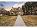 Charming two-story home features a welcoming walkway and well-maintained front yard at 56 Linneys Mountain Rd, Taylorsville, NC 28681