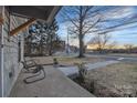 Inviting front porch featuring seating area overlooking the landscaped yard, perfect for relaxing outdoors at 56 Linneys Mountain Rd, Taylorsville, NC 28681