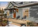 Inviting front porch featuring stylish chairs and a wreath on the wooden door at 56 Linneys Mountain Rd, Taylorsville, NC 28681